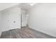 Bright bedroom with wood-look flooring, white walls, and closet with double doors at 23 N Edwards St, Plant City, FL 33563