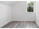 Bright bedroom with gray wood-look floors and a window providing natural light at 23 N Edwards St, Plant City, FL 33563