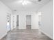 Bright room featuring wood-look flooring, white walls, and doors leading to closet and bathroom at 23 N Edwards St, Plant City, FL 33563