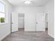 A bright bedroom with wood-look flooring, white walls, and closet at 23 N Edwards St, Plant City, FL 33563