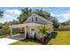View of home featuring landscaped yard, carport, and neutral-toned exterior at 23 N Edwards St, Plant City, FL 33563