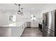 Modern kitchen features stainless steel appliances, white cabinets, and expansive countertops at 23 N Edwards St, Plant City, FL 33563