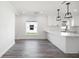 Bright kitchen with white cabinetry, modern fixtures, and wood-look flooring at 23 N Edwards St, Plant City, FL 33563
