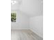 Bright bedroom featuring wood-look tile flooring, windows, and an airy atmosphere at 25 W Edwards St, Plant City, FL 33563