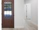 Hallway with wood flooring, decorative front door and freshly painted walls at 25 W Edwards St, Plant City, FL 33563