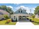 Inviting two-story home featuring lush landscaping, a quaint covered porch, and a freshly paved walkway at 25 W Edwards St, Plant City, FL 33563