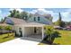Beautiful home featuring lush landscaping, a quaint covered porch, and a freshly paved walkway at 25 W Edwards St, Plant City, FL 33563