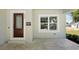Close up of the home's entrance featuring a decorative wood door and covered porch at 25 W Edwards St, Plant City, FL 33563