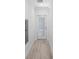 Hallway featuring tile flooring and a door with a glass window and blinds at 25 W Edwards St, Plant City, FL 33563