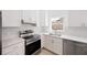 Clean white kitchen featuring stainless steel appliances, white cabinets and drawers, and solid surface countertops at 25 W Edwards St, Plant City, FL 33563