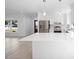Open floor plan with kitchen featuring stainless steel appliances, large countertop, and ample cabinet space at 25 W Edwards St, Plant City, FL 33563