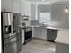 Modern kitchen features stainless steel appliances, white cabinetry, and sleek countertops, perfect for cooking at 25 W Edwards St, Plant City, FL 33563