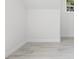 Bright living room featuring wood-look tile flooring and a window for natural light at 25 W Edwards St, Plant City, FL 33563