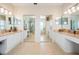 Spacious bathroom with dual vanities, granite countertops, and mirrored closet doors at 2733 Via Cipriani # 814A, Clearwater, FL 33764