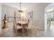 Bright dining room with a large wooden table, seating for six, and elegant overhead lighting at 2733 Via Cipriani # 814A, Clearwater, FL 33764