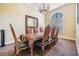 Formal dining room features elegant table with chairs, chandelier, mirror, and arch window at 2733 Via Cipriani # 814A, Clearwater, FL 33764