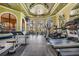 Community gym featuring wood-look floors, ceiling fan, arched windows, and treadmills at 2733 Via Cipriani # 814A, Clearwater, FL 33764