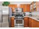 Kitchen with stainless steel appliances, granite countertops, and light-colored tile flooring at 2733 Via Cipriani # 814A, Clearwater, FL 33764