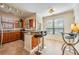 Modern kitchen with stainless steel appliances, wood cabinets, granite counters, and bar seating at 2733 Via Cipriani # 814A, Clearwater, FL 33764