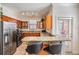 Bright kitchen boasts stainless steel appliances, wood cabinets, and granite countertops with bar seating at 2733 Via Cipriani # 814A, Clearwater, FL 33764