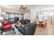 Elegant living room with dark sofas, stylish glass display cabinet, and an adjacent dining area at 2733 Via Cipriani # 814A, Clearwater, FL 33764