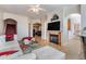 Inviting living room showcases a fireplace, large TV, and comfortable seating, with stairs and kitchen views at 2733 Via Cipriani # 814A, Clearwater, FL 33764