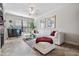 Bright living room featuring a large white sectional, stylish glass coffee table, and sleek wet bar at 2733 Via Cipriani # 814A, Clearwater, FL 33764