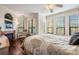 Bright main bedroom with hardwood floors, fireplace, and multiple windows offering natural light and scenic views at 2733 Via Cipriani # 814A, Clearwater, FL 33764