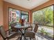 Screened-in patio featuring a table, chairs, and view of the landscaped yard at 2733 Via Cipriani # 814A, Clearwater, FL 33764