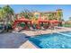 Inviting pool area with lounge seating under covered cabanas and tropical landscaping at 2733 Via Cipriani # 814A, Clearwater, FL 33764