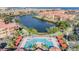 Aerial view of the pool area with covered seating, tropical landscaping and the canal at 2733 Via Cipriani # 814A, Clearwater, FL 33764