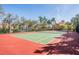 Community tennis court with palm tree views, landscaping, and building in background at 2733 Via Cipriani # 814A, Clearwater, FL 33764