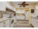 Well-lit kitchen featuring granite countertops, stainless appliances, and wood-look vinyl flooring at 2995 Flint S Dr, Clearwater, FL 33759