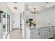 Kitchen featuring a large marble island, stainless appliances, modern light fixtures, and stylish white cabinetry at 3117 W Barcelona St # A, Tampa, FL 33629