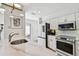 Bright kitchen with stainless steel appliances, white cabinets, marble countertops, and subway tile backsplash at 3117 W Barcelona St # A, Tampa, FL 33629