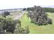 Aerial view showing lush landscape with distant community and winding roads at 32817 Leonard Rd, San Antonio, FL 33576