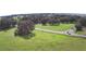 Lush green space aerial view with a peaceful country road at 32817 Leonard Rd, San Antonio, FL 33576