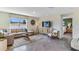 Contemporary living room with modern furniture, tile floors, and a view into the bedroom at 3521 Thistle Bank Ct, Plant City, FL 33565