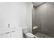 Modern bathroom with a walk-in shower, white vanity, and sleek toilet at 400 150Th Ave # 206, Madeira Beach, FL 33708