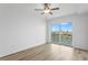 Bright bedroom with wood floors and sliding glass doors to the balcony with waterfront views at 400 150Th Ave # 206, Madeira Beach, FL 33708