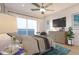 Bedroom featuring a large window view, ceiling fan, gray toned bedding, and a modern dresser at 400 150Th Ave # 206, Madeira Beach, FL 33708