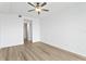 Bright bedroom features a modern ceiling fan, neutral color palette, and wood-look flooring at 400 150Th Ave # 206, Madeira Beach, FL 33708