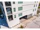 Building exterior featuring multiple balconies and an attached garage with parking at 400 150Th Ave # 206, Madeira Beach, FL 33708