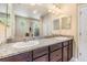Bathroom with a large mirror, granite counters, and double sinks at 450 Harbor Springs Dr, Palm Harbor, FL 34683