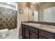 Bathroom featuring a granite countertop vanity and shower with decorative curtain at 450 Harbor Springs Dr, Palm Harbor, FL 34683