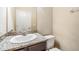 Bathroom with a dark wood vanity, granite countertop, and neutral-colored walls at 450 Harbor Springs Dr, Palm Harbor, FL 34683