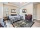 Neutral bedroom with tray ceilings, a ceiling fan, and a compass-themed rug at 450 Harbor Springs Dr, Palm Harbor, FL 34683