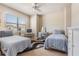 Bright bedroom with twin beds, ceiling fan, and a dedicated vanity area at 450 Harbor Springs Dr, Palm Harbor, FL 34683