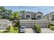 Charming two-story home with a two-car garage and well-manicured landscaping at 450 Harbor Springs Dr, Palm Harbor, FL 34683