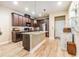 Beautiful kitchen featuring an island with a granite countertop and modern appliances at 450 Harbor Springs Dr, Palm Harbor, FL 34683